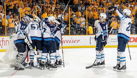 NASHVILLE, TN – MAY 10: Connor Hellebuyck #37 of the Winnipeg Jets is congratulated by teammates after a 5-1 win in Game Seven of the Western Conference Second Round during the 2018 NHL Stanley Cup Playoffs at Bridgestone Arena on May 10, 2018 in Nashville, Tennessee. (Photo by John Russell/NHLI via Getty Images)