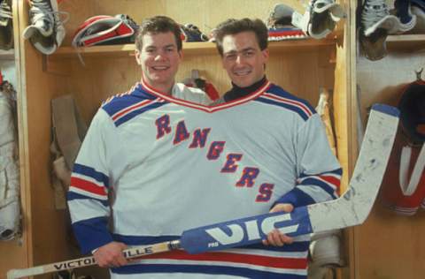 American hockey players Mike Richter (left) and John Vanbiesbrouck, both goalies for the New York Rangers, pose together in one large jersey, January 1991. (Photo by Bruce Bennett Studios/Getty Images)