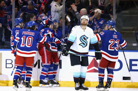 NEW YORK, NEW YORK – FEBRUARY 10: Adam Larsson #6 of the Seattle Kraken looks at the scoreboard as the New York Rangers celebrate a third-period goal by Mika Zibanejad #93 at Madison Square Garden on February 10, 2023, in New York City. The Rangers defeated the Kraken 6-3. (Photo by Bruce Bennett/Getty Images)