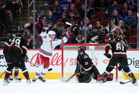 Dec 15, 2021; Glendale, Arizona, USA; New York Rangers right wing Kaapo Kakko (24) scores a goal against Arizona Coyotes goalie Scott Wedgewood (31) during the third period at Gila River Arena. Mandatory Credit: Joe Camporeale-USA TODAY Sports