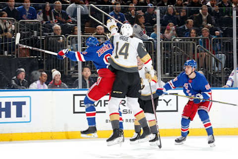 NEW YORK, NY – DECEMBER 02: Mika Zibanejad #93 of the New York Rangers and Nicolas Hague #14 of the Vegas Golden Knights jump for the puck at Madison Square Garden on December 2, 2019 in New York City. (Photo by Jared Silber/NHLI via Getty Images)