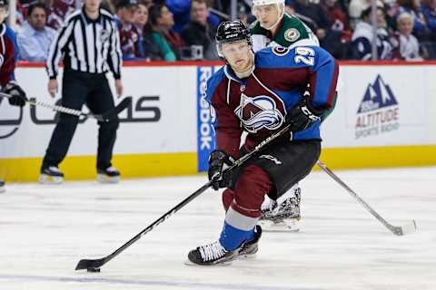 Apr 6, 2017; Denver, CO, USA; Colorado Avalanche center Nathan MacKinnon (29) controls the puck in the third period against the Minnesota Wild at the Pepsi Center. The Wild won 4-3. Mandatory Credit: Isaiah J. Downing-USA TODAY Sports