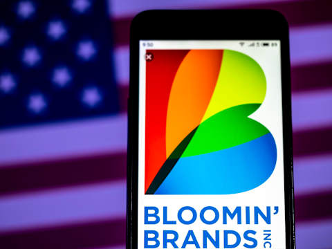 KIEV, UKRAINE – 2019/01/10: In this photo illustration, the Bloomin’ Brands Hospitality company logo seen displayed on a smartphone. (Photo Illustration by Igor Golovniov/SOPA Images/LightRocket via Getty Images)