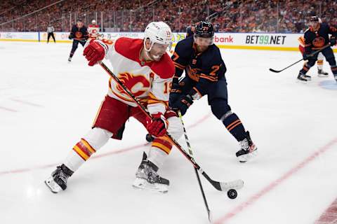 iEDMONTON, AB – MAY 24: Matthew Tkachuk #19 of the Calgary Flames battles against Brett Kulak #27 of the Edmonton Oilers during the third period in Game Four of the Second Round of the 2022 Stanley Cup Playoffs at Rogers Place on May 24, 2022 in Edmonton, Canada. (Photo by Codie McLachlan/Getty Images)