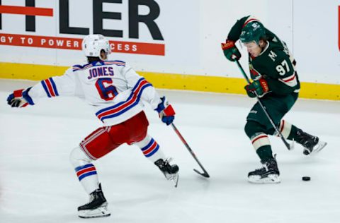 ST PAUL, MN – OCTOBER 13: Kirill Kaprizov #97 of the Minnesota Wild skates with the puck while Zac Jones #6 of the New York Rangers defends in the second period of the game at Xcel Energy Center on October 13, 2022 in St Paul, Minnesota. The Rangers defeated the Wild 7-3. (Photo by David Berding/Getty Images)