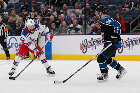 Jan 16, 2023; Columbus, Ohio, USA; New York Rangers center Vincent Trocheck (16) wrists a shot on goal as Columbus Blue Jackets center Jack Roslovic (96) defends during the third period at Nationwide Arena. Mandatory Credit: Russell LaBounty-USA TODAY Sports