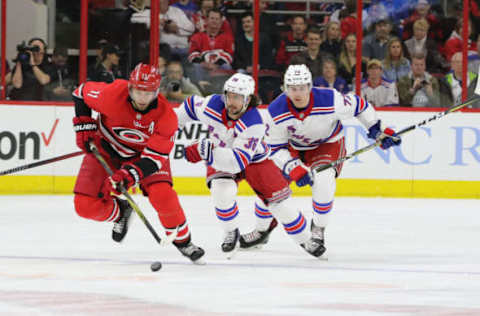 RALEIGH, NC – MARCH 31: Carolina Hurricanes Center Jordan Staal (11) goes for the puck with New York Rangers Right Wing Mats Zuccarello (36) closely behind during the 2nd period of the Carolina Hurricanes game versus the New York Rangers on March 31, 2018, at PNC Arena (Photo by Jaylynn Nash/Icon Sportswire via Getty Images)