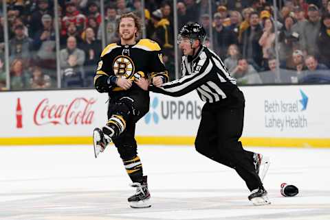 BOSTON, MA – DECEMBER 23: Boston Bruins right wing David Pastrnak (88) is escorted to the penalty box by linesman Ryan Daisy (81) during a game between the Boston Bruins and the Washington Capitals on December 23, 2019 at TD Garden in Boston, Massachusetts. (Photo by Fred Kfoury III/Icon Sportswire via Getty Images)