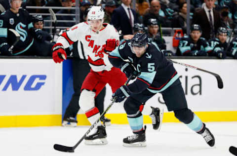 SEATTLE, WASHINGTON – NOVEMBER 24: Martin Necas #88 of the Carolina Hurricanes defends Mark Giordano #5 of the Seattle Kraken during the first period at Climate Pledge Arena on November 24, 2021, in Seattle, Washington. (Photo by Steph Chambers/Getty Images)