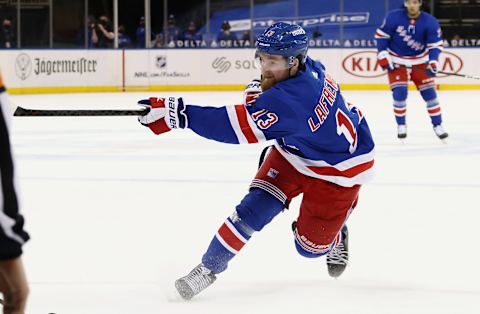 NEW YORK, NEW YORK – APRIL 27: Alexis Lafreniere #13 of the New York Rangers takes a slapshot against the Buffalo Sabres at Madison Square Garden on April 27, 2021 in New York City. The Rangers defeated the Sabres 3-1. (Photo by Bruce Bennett/Getty Images)