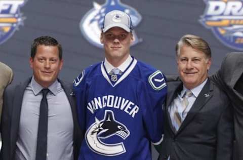 Jun 24, 2016; Buffalo, NY, USA; Olli Juolevi poses for a photo after being selected as the number five overall draft pick by the Vancouver Canucks in the first round of the 2016 NHL Draft at the First Niagra Center. Mandatory Credit: Timothy T. Ludwig-USA TODAY Sports