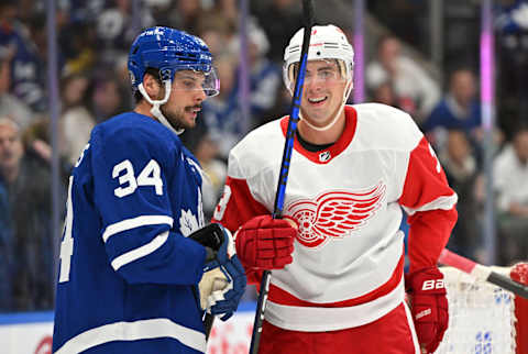 Oct 5, 2023; Toronto, Ontario, CAN; Toronto Maple Leafs forward Auston Matthews (34) speaks to former team mate Detroit Red Wings defenseman Justin Holl (3) in the third period at Scotiabank Arena. Mandatory Credit: Dan Hamilton-USA TODAY Sports