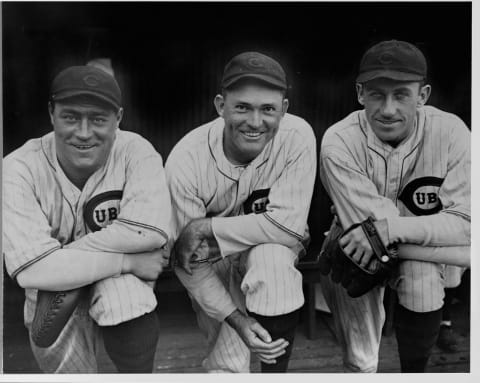 Hack Wilson, Rogers Hornsby, and Kiki Cuyler in full uniform in a dugout. (Photo by Library of Congress/Corbis/VCG via Getty Images)