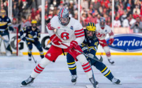 CLEVELAND, OH FEBRUARY 18: Mason Lohrei #6 of the Ohio State Buckeyes battles for the puck against Rutger McGroarty #2 of the Michigan Wolverines during the first period of the Faceoff on the Lake NCAA ice hockey game at FirstEnergy Stadium on February 18, 2023 in Cleveland, OH. Ohio State beat Michigan with a final score of 4-2. (Photo by Jaime Crawford/Getty Images)