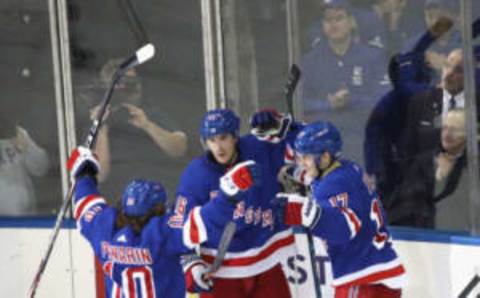 Artemi Panarin #10, Ryan Strome #16 and Jesper Fast #17 of the New York Rangers celebrate a third-period goal