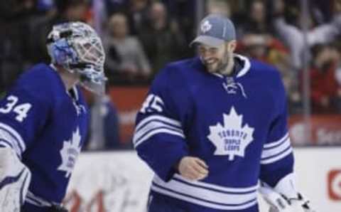 Dec 14, 2014; Toronto, Ontario, CAN; Toronto Maple Leafs goaltender James Reimer (34) and goaltender Jonathan Bernier (45) skate off the ice after a win over the Los Angeles Kings at the Air Canada Centre. Toronto defeated Los Angeles 4-3 in an overtime shot out. Mandatory Credit: John E. Sokolowski-USA TODAY Sports