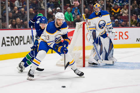 Mar 20, 2022; Vancouver, British Columbia, CAN; Vancouver Canucks forward Elias Pettersson (40) skates after Buffalo Sabres defenseman Colin Miller (33) in the first period at Rogers Arena. Mandatory Credit: Bob Frid-USA TODAY Sports