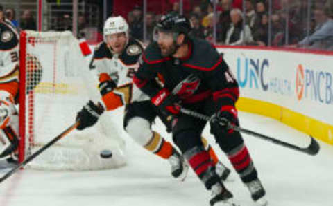 Feb 25, 2023; Raleigh, North Carolina, USA; Carolina Hurricanes left wing Jordan Martinook (48) skates with the puck against Anaheim Ducks defenseman Dmitry Kulikov (29) during the first period at PNC Arena. Mandatory Credit: James Guillory-USA TODAY Sports