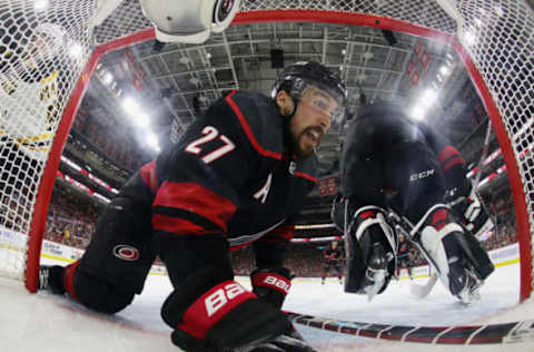 RALEIGH, NORTH CAROLINA – MAY 16: Justin Faulk #27 of the Carolina Hurricanes slides into the net during the third period against the Boston Bruins in Game Four of the Eastern Conference Final during the 2019 NHL Stanley Cup Playoffs at the PNC Arena on May 16, 2019 in Raleigh, North Carolina. The Bruins defeated the Hurricanes 4-0 to move on to the Stanley Cup Finals. (Photo by Bruce Bennett/Getty Images)