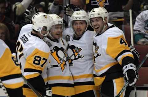 NHL Team Name Origins: Pittsburgh Penguins players Sidney Crosby (87), Chris Kunitz (14), Kris Letang and Justin Schultz (4) celebrate after a goal against the Anaheim Ducks at Honda Center. Mandatory Credit: Kirby Lee-USA TODAY Sports