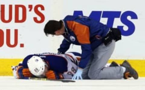 Mar 6, 2016; Winnipeg, Manitoba, CAN; Edmonton Oilers defenseman Brandon Davidson (88) is injured during the first period against the Winnipeg Jets at MTS Centre. Mandatory Credit: Bruce Fedyck-USA TODAY Sports