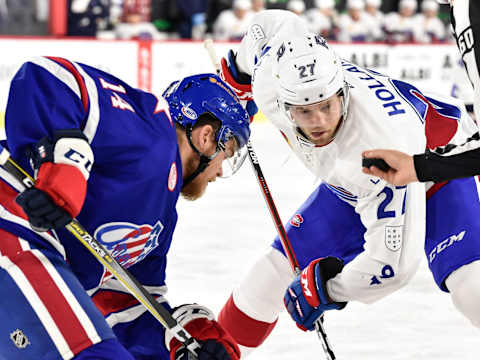 LAVAL, QC – OCTOBER 25: Peter Holland #27 of the Laval Rocket watches the puck as he prepares to take a faceoff against Sean Malone #14 of the Rochester Americans during the AHL game at Place Bell on October 25, 2017 in Montreal, Laval, Canada. (Photo by Minas Panagiotakis/Getty Images)