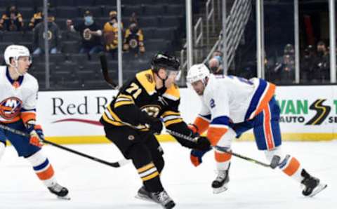 May 10, 2021; Boston, Massachusetts, USA; Boston Bruins left wing Taylor Hall (71) scores the winning goal in overtime while New York Islanders defenseman Nick Leddy (2) defends at TD Garden. Mandatory Credit: Bob DeChiara-USA TODAY Sports