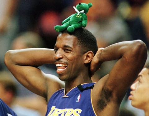 Los Angeles Lakers player A.C. Green stands with a green Beanie Baby bear on his head during a game in 2000.