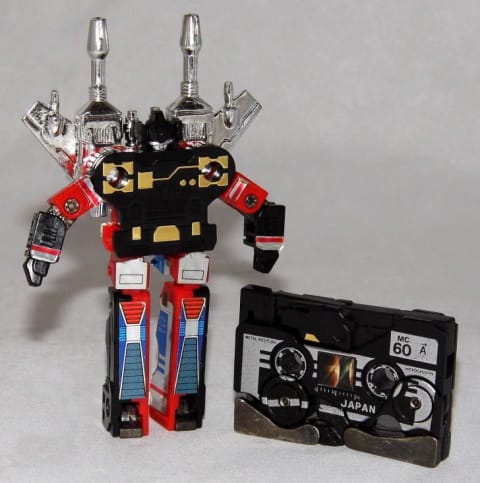 A Transformers action figure and cassette