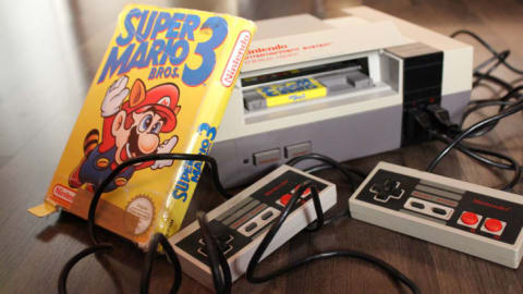 A Super Mario Bros. 3 game next to an NES console