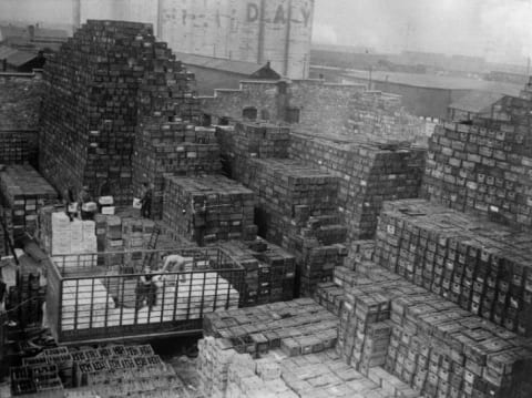 Workmen unloading crates of beer stacked at a New York brewery shortly after the repeal of Prohibition.