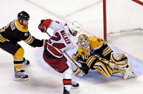 Carolina Hurricanes’ Scott Walker (24) puts the game-winning shot past Boston Bruins’ Dennis Wideman (6) and Tim Thomas (30) during overtime action in Game 7 of the NHL Eastern Conference playoffs at the TD Banknorth Garden in Boston Massachusetts, Thursday May 14, 2009. The Canes defeated the Bruins 3-2. (Photo by Chris Seward/Raleigh News & Observer/MCT via Getty Images)