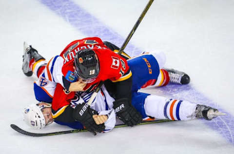 Sep 26, 2016; Calgary, Alberta, CAN; Calgary Flames left wing Matthew Tkachuk (19) and Edmonton Oilers Josh Currie (43) fight during a preseason hockey game at Scotiabank Saddledome. Edmonton Oilers won 2-1. Mandatory Credit: Sergei Belski-USA TODAY Sports