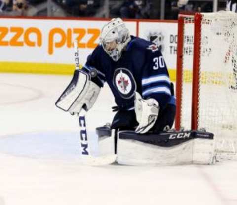 Jan 18, 2016; Winnipeg, Manitoba, CAN; Winnipeg Jets goalie Connor Hellebuyck (30) makes a save during the third period against the Colorado Avalanche at MTS Centre. Colorado wins 2-1. Mandatory Credit: Bruce Fedyck-USA TODAY Sports