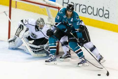 Mar 28, 2016; San Jose, CA, USA; San Jose Sharks center Joe Thornton (19) rounds goal as Los Angeles Kings goalie Jonathan Quick (32) defends in the third period at SAP Center at San Jose. The Sharks won 5-2. Mandatory Credit: John Hefti-USA TODAY Sports