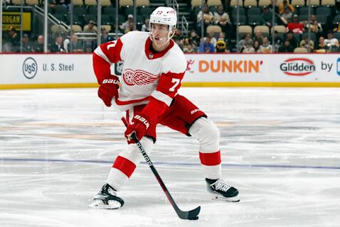 Oct 4, 2023; Pittsburgh, Pennsylvania, USA; Detroit Red Wings defenseman Simon Edvinsson (77) handles the puck against the Pittsburgh Penguins during the second period at PPG Paints Arena. Mandatory Credit: Charles LeClaire-USA TODAY Sports