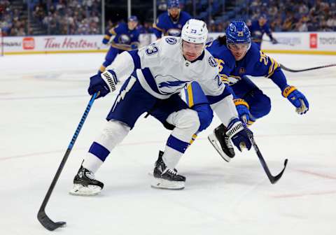 Oct 17, 2023; Buffalo, New York, USA; Tampa Bay Lightning center Michael Eyssimont (23) skates to the net as Buffalo Sabres defenseman Owen Power (25) tries to defend during the third period at KeyBank Center. Mandatory Credit: Timothy T. Ludwig-USA TODAY Sports