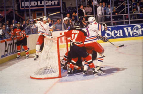 Canadian ice hockey player Stephane Matteau of the New York Rangers (with stick raised above his head) scores the winning goal during the second overtime period of the 7th game of the Stanley Cup sermi-finals, allowing the Rangers to defeat the New Jersey Devils and advance to the finals, New York, New York, May 27, 1994. (Photo by Bruce Bennett Studios via Getty Images/Getty Images)