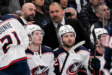 Apr 4, 2023; Toronto, Ontario, CAN; Columbus Blue Jackets head coach Brad Larsen listens to an assistant coach during the third period against the Toronto Maple Leafs at Scotiabank Arena. Mandatory Credit: John E. Sokolowski-USA TODAY Sports