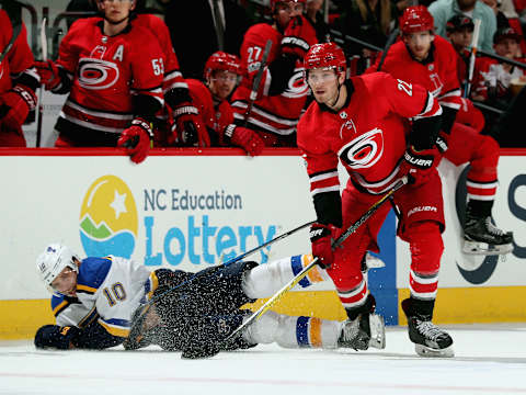 RALEIGH, NC – OCTOBER 27: Brett Pesce #22 of the Carolina Hurricanes collects the puck as Brayden Schenn #10 of the St. Louis Blues falls to the ice during an NHL game on October 27, 2017 at PNC Arena in Raleigh, North Carolina. (Photo by Gregg Forwerck/NHLI via Getty Images)