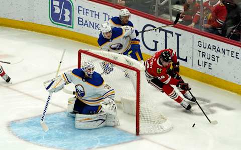 Mar 28, 2022; Chicago, Illinois, USA; Chicago Blackhawks center Sam Lafferty (24) skates in on Buffalo Sabres goaltender Dustin Tokarski (31) during the second period at United Center. Mandatory Credit: David Banks-USA TODAY Sports