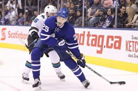 Dec 13, 2016; Toronto, Ontario, CAN; Toronto Maple Leafs left wing James van Riemsdyk (25) skates ariund the net with the puck as San Jose Sharks defenseman David Schlemko (5) pursues at Air Canada Centre. Mandatory Credit: Tom Szczerbowski-USA TODAY Sports