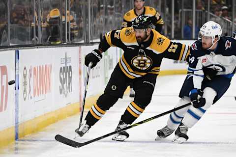 BOSTON, MASSACHUSETTS – DECEMBER 22: Nick Foligno #17 of the Boston Bruins and Dylan Samberg #54 of the Winnipeg Jets battle for the puck during the first period at the TD Garden on December 22, 2022, in Boston, Massachusetts. (Photo by Brian Fluharty/Getty Images)