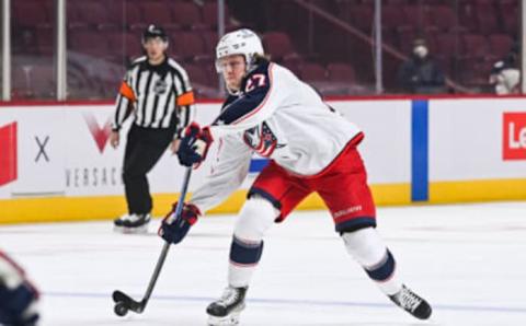 Jan 30, 2022; Montreal, Quebec, CAN; Columbus Blue Jackets defenseman Adam Boqvist (27) plays the puck during the first period at Bell Centre. Mandatory Credit: David Kirouac-USA TODAY Sports