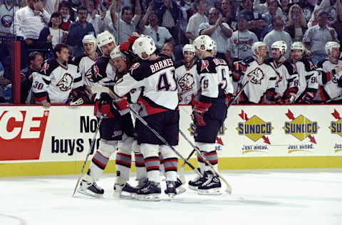 29 May 1999: Rob Ray #32 of the Buffalo Sabres is hugged by teammates after his goal during the game against the Toronto Maple Leafs at the Marine Midland Arena in Buffalo, New York. The Sabres defeated the Maple Leavs 5-2. Mandatory Credit: Elsa Hasch /Allsport