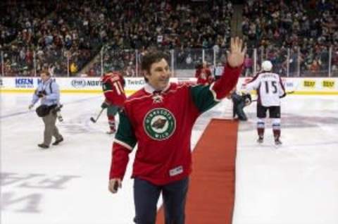 Feb 14, 2013; St. Paul, MN, USA; Minnesota Wild former forward Andrew Brunette (15) waves to the crowd prior to the game against the Colorado Avalanche at the Xcel Energy Center. The Avalanche defeated the Wild 4-3 in a shootout. Mandatory Credit: Brace Hemmelgarn-USA TODAY Sports