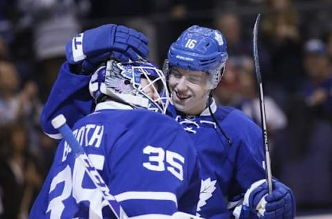 Nov 5, 2016; Toronto, Ontario, CAN; Toronto Maple Leafs forward Mitchell Marner (16) celebrates a win over the Vancouver Canucks with goaltender Jhonas Enroth (35) at Air Canada Centre. Toronto defeated Vancouver 6-3. Mandatory Credit: John E. Sokolowski-USA TODAY Sports