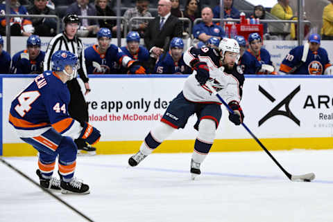 Dec 7, 2023; Elmont, New York, USA; Columbus Blue Jackets defenseman Ivan Provorov (9) passes the puck as New York Islanders center Jean-Gabriel Pageau (44) defends during the first period at UBS Arena. Mandatory Credit: John Jones-USA TODAY Sports