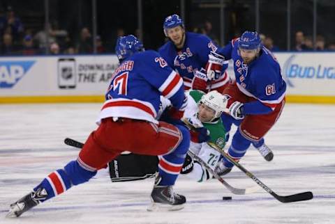 Feb 8, 2015; New York, NY, USA; Dallas Stars right wing Erik Cole (72) falls to the ice between New York Rangers defenseman Ryan McDonagh (27) and left wing Rick Nash (61) during the second period at Madison Square Garden. Mandatory Credit: Adam Hunger-USA TODAY Sports