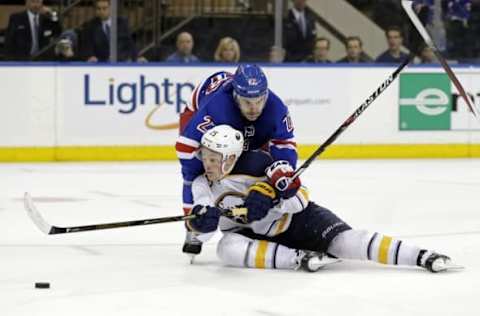 Apr 2, 2016; New York, NY, USA; Buffalo Sabres center Jack Eichel (15) falls to the ice defended by New York Rangers defenseman Dan Boyle (22) during the third period at Madison Square Garden. The Sabres defeated the Rangers 4-3. Mandatory Credit: Adam Hunger-USA TODAY Sports